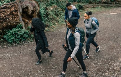A diverse group of friends enjoying a hike through a lush forest trail. — Find Salt Lake City's Best Ski Gear Rental